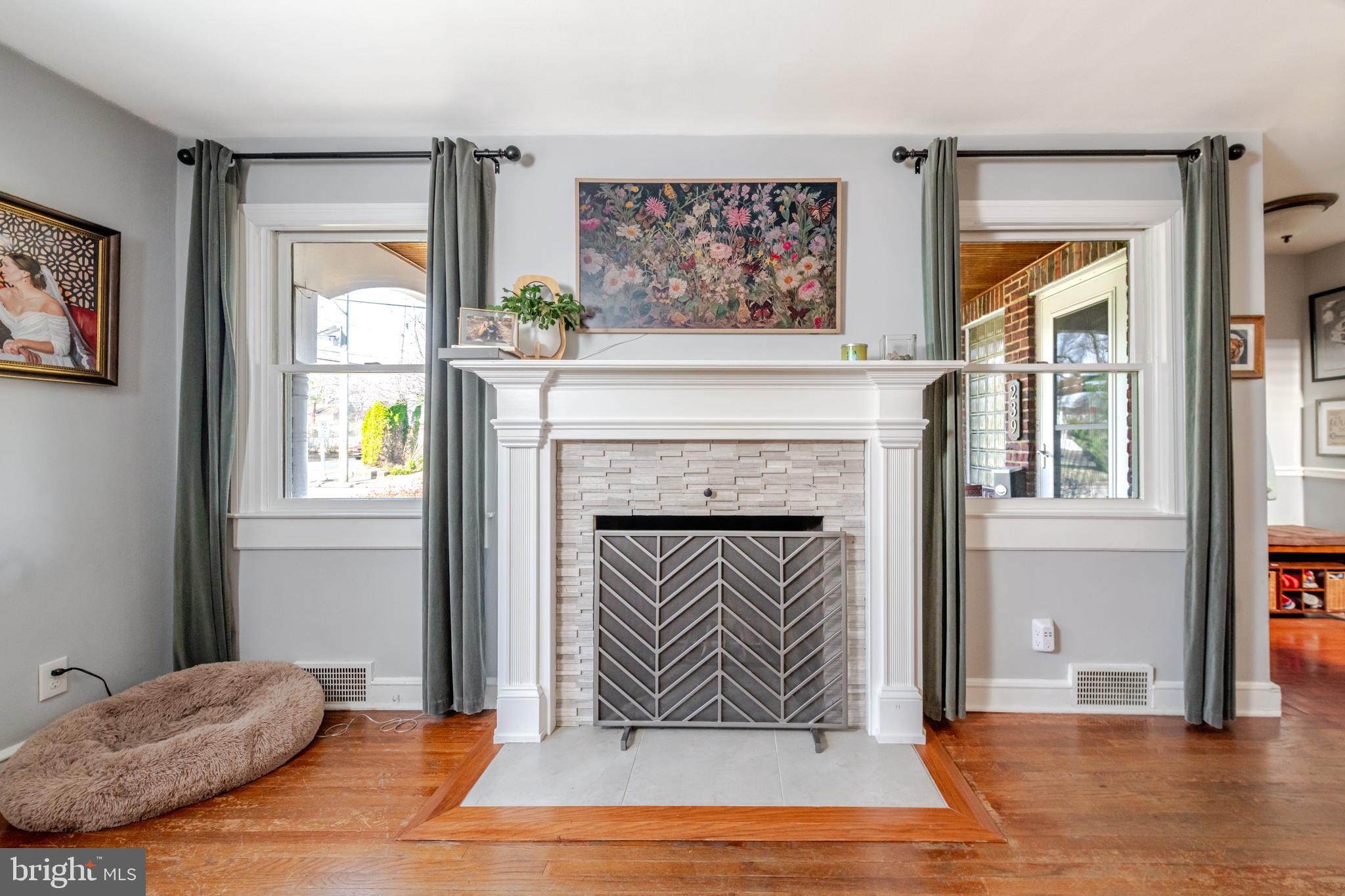 239 Hopkins Road Haddonfield, NJ 08033 - Photo 12 of 76 a living room with a fireplace with wooden floor