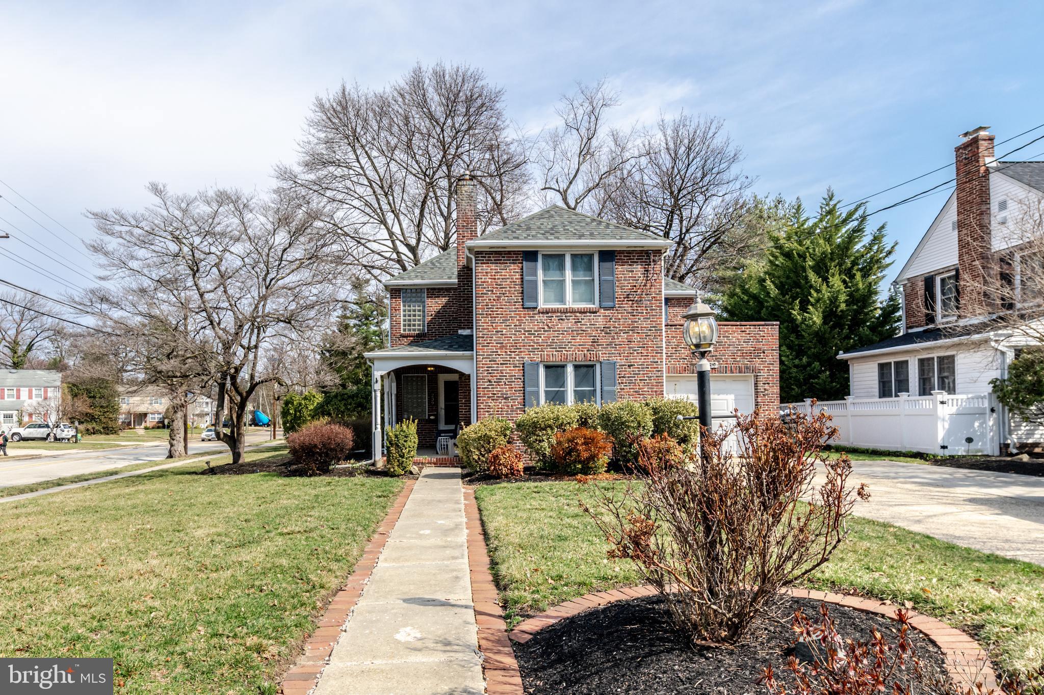 239 Hopkins Road Haddonfield, NJ 08033 - Photo 4 of 76 a front view of a house with a yard