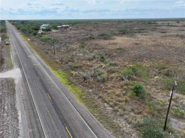 a view of a balcony with a yard