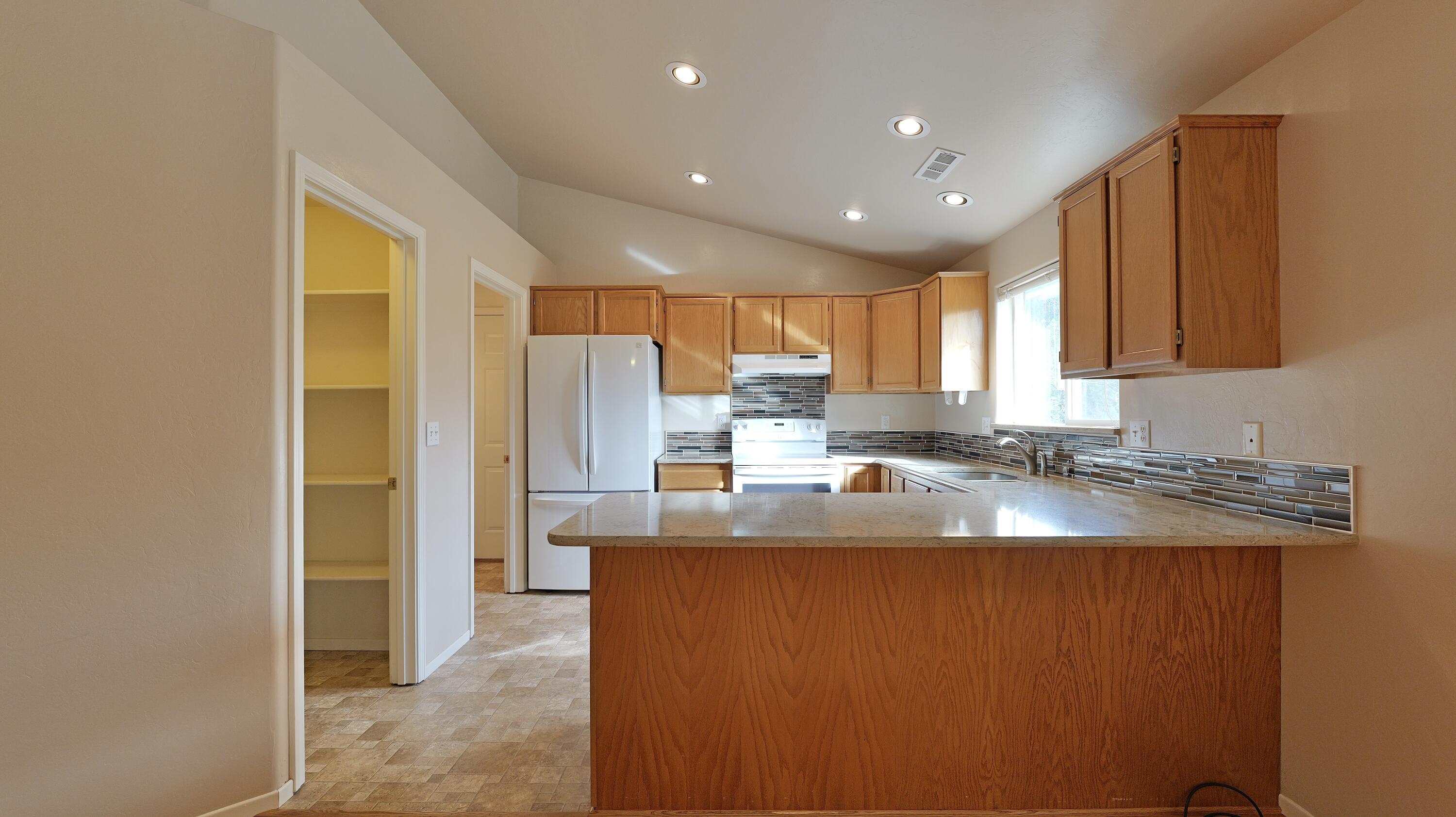 204 Shipley Terrace Prospect, OR 97536 - Photo 8 of 61 a kitchen with stainless steel appliances granite countertop a sink a stove and a refrigerator with wooden floor