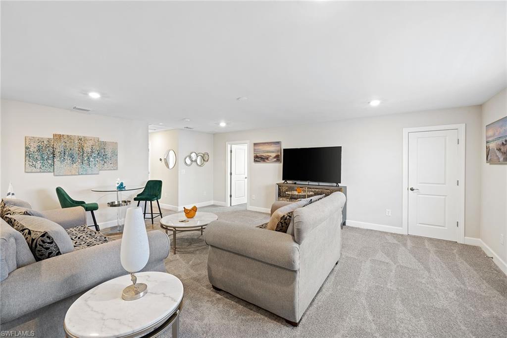 1973 Yellowfin Circle Naples, FL 34114 - Photo 13 of 44 a living room with furniture and a flat screen tv