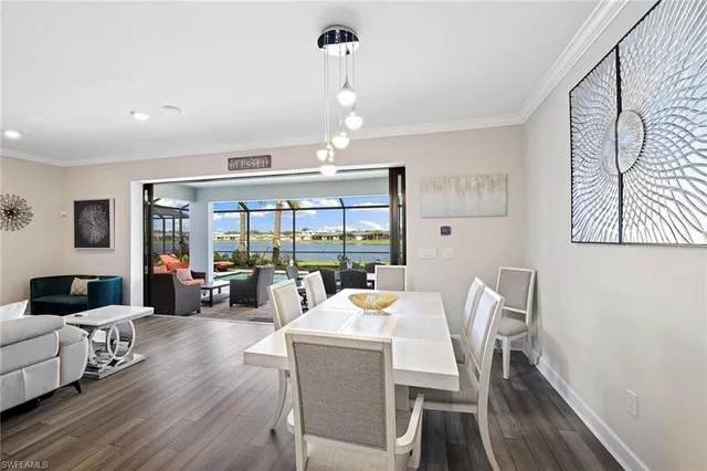 a view of a dining room with furniture wooden floor and chandelier