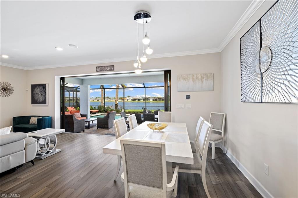 1973 Yellowfin Circle Naples, FL 34114 - Photo 14 of 44 a view of a dining room with furniture wooden floor and chandelier