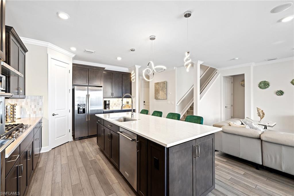 1973 Yellowfin Circle Naples, FL 34114 - Photo 21 of 44 a large kitchen with stainless steel appliances kitchen island a large counter top and sink