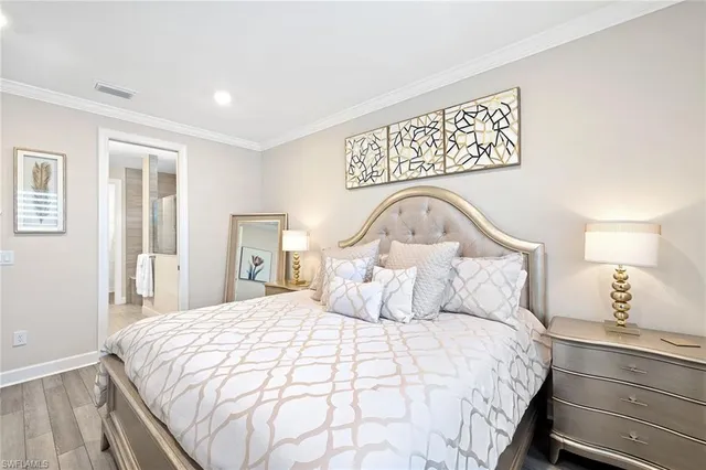 a bedroom with a bed and a night stand