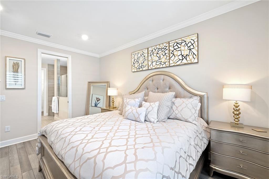 1973 Yellowfin Circle Naples, FL 34114 - Photo 23 of 44 a bedroom with a bed and a night stand