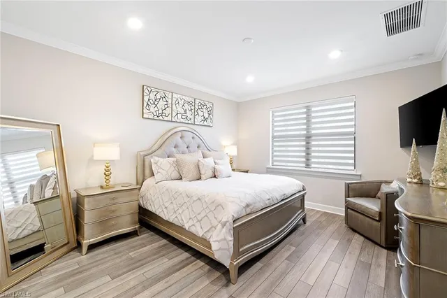 a bedroom with a bed and flat screen tv