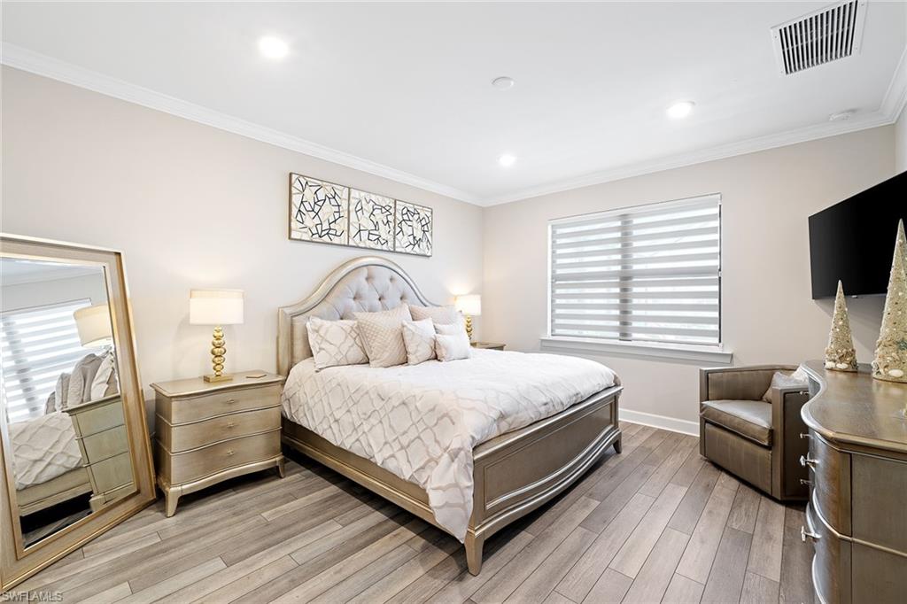 1973 Yellowfin Circle Naples, FL 34114 - Photo 24 of 44 a bedroom with a bed and flat screen tv