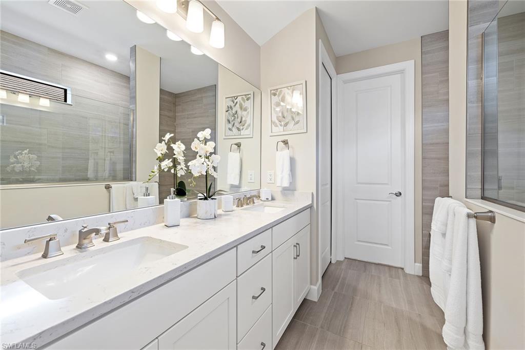 1973 Yellowfin Circle Naples, FL 34114 - Photo 27 of 44 a bathroom with a double vanity sink mirror and next to a window