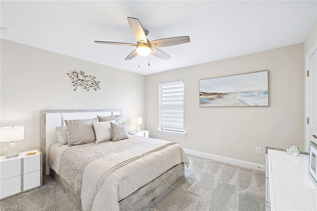 1973 Yellowfin Circle Naples, FL 34114 - Photo 32 of 44 a bedroom with a large bed and a window