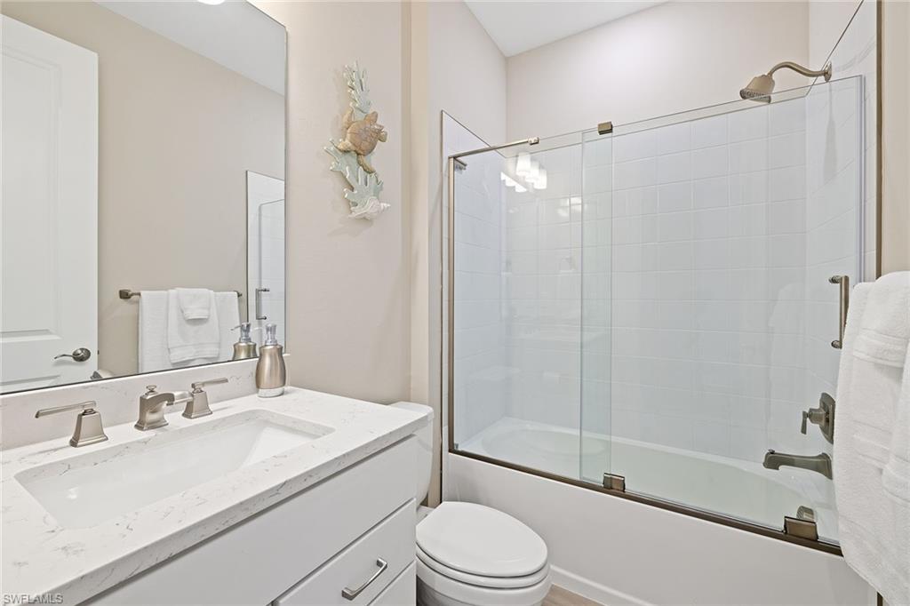 1973 Yellowfin Circle Naples, FL 34114 - Photo 34 of 44 a bathroom with a sink a toilet and shower