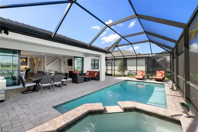 a view of a swimming pool with chairs in patio