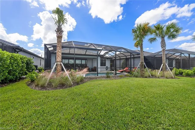 a front view of a house with backyard and sitting area