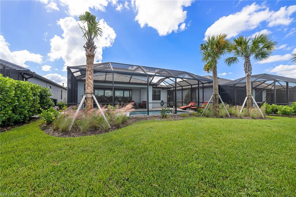 1973 Yellowfin Circle Naples, FL 34114 - Photo 42 of 44 a front view of a house with backyard and sitting area