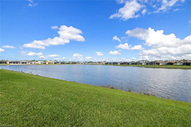 a view of a lake with houses in the back