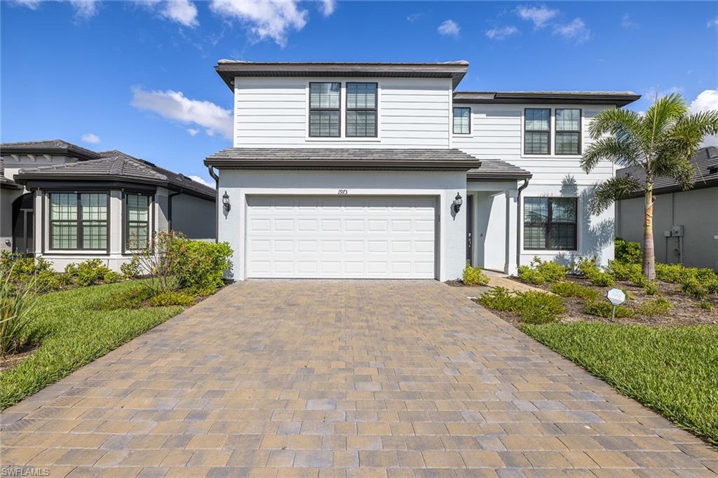 1973 Yellowfin Circle Naples, FL 34114 - Photo 5 of 44 a front view of a house with a yard and garage