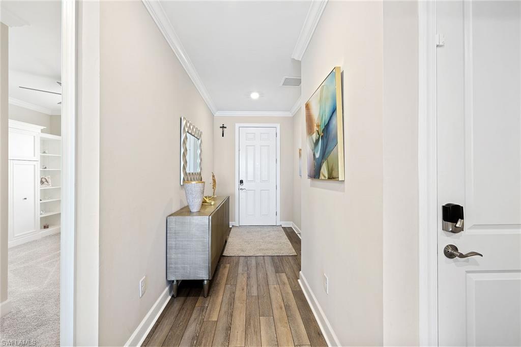 1973 Yellowfin Circle Naples, FL 34114 - Photo 7 of 44 a view of a hallway with wooden floor and staircase