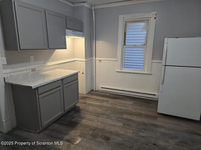 a kitchen with a refrigerator and cabinets