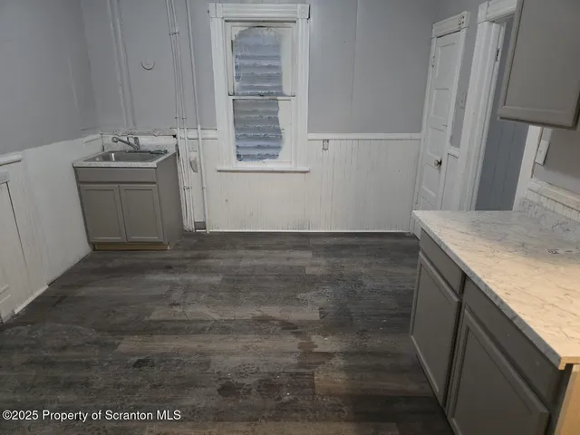 a room with a sink and cabinets