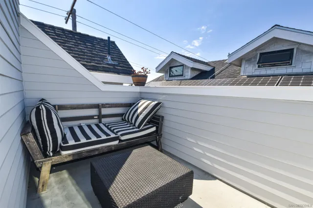 a view of staircase with lots of frames on wall and a window