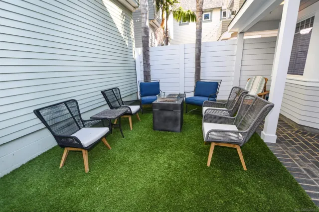 a couple of chairs sitting in backyard of house