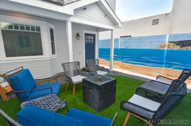 a backyard of a house with outdoor seating