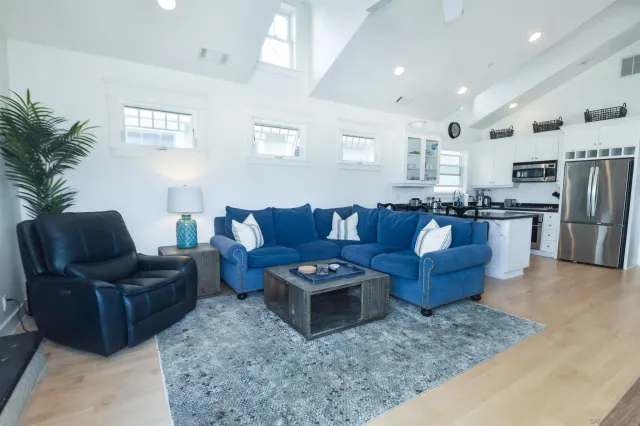 a living room with furniture and kitchen view