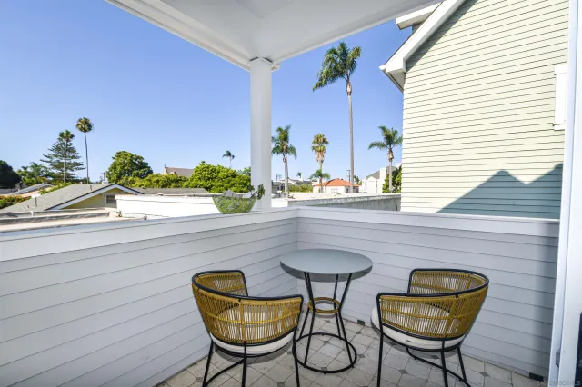 a view of a chairs and table in a balcony