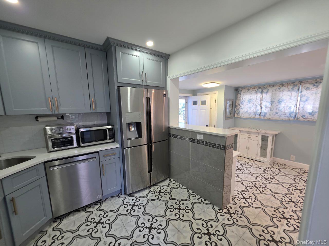 30 Aberdeen Road New Hyde Park, NY 11040 - Photo 35 of 37 a kitchen with stainless steel appliances granite countertop a refrigerator and a sink