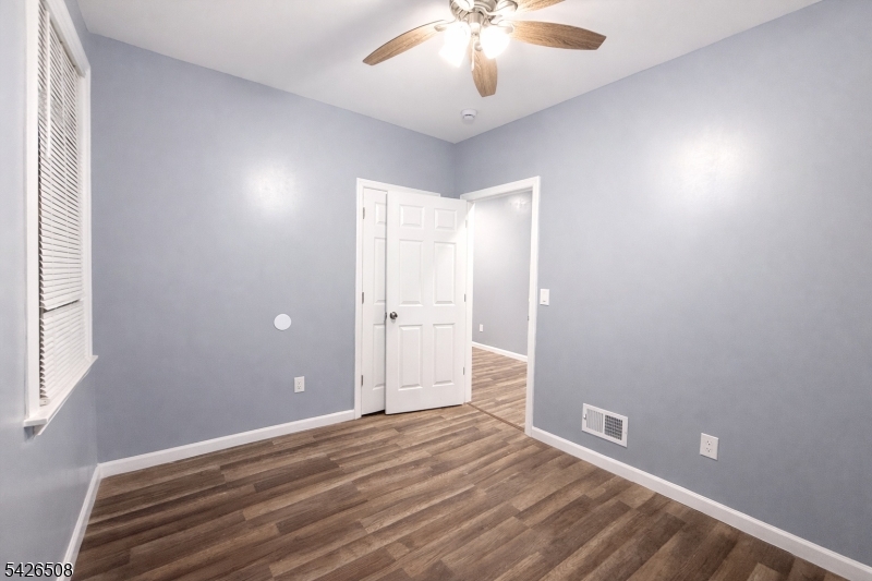 411 South 16th Street, Unit 1 Newark, NJ 07103 - Photo 11 of 39 wooden floor in an empty room with a window