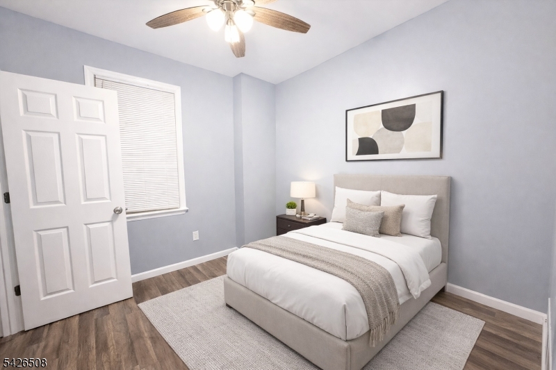 411 South 16th Street, Unit 1 Newark, NJ 07103 - Photo 13 of 39 a bedroom with a large bed and a chandelier