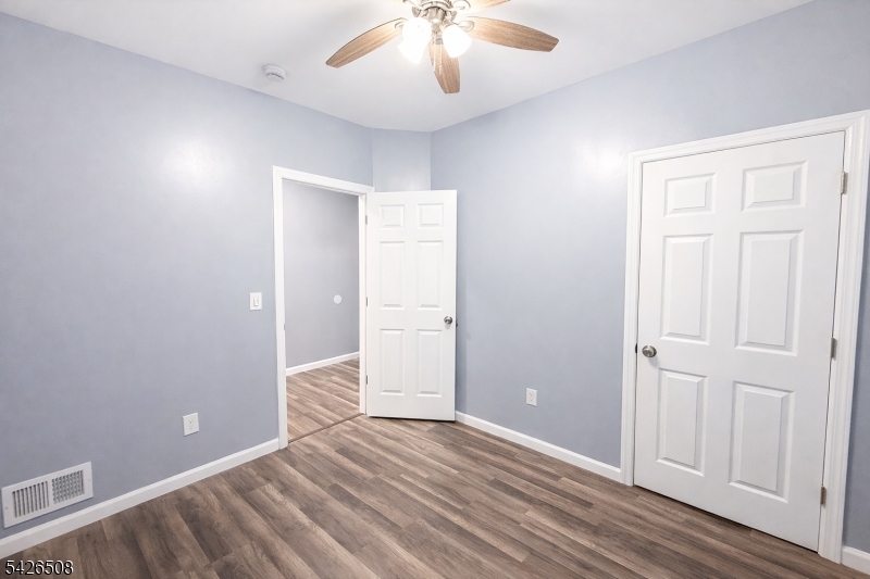 411 South 16th Street, Unit 1 Newark, NJ 07103 - Photo 14 of 39 an empty room with wooden floor and windows