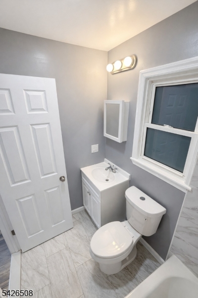 411 South 16th Street, Unit 1 Newark, NJ 07103 - Photo 18 of 39 a white toilet sitting next to a bathroom sink