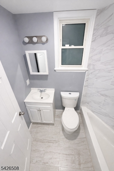 411 South 16th Street, Unit 1 Newark, NJ 07103 - Photo 20 of 39 a white toilet sitting next to a bathroom sink