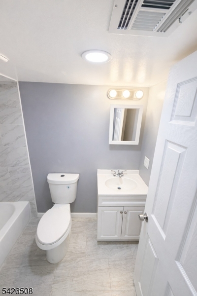 411 South 16th Street, Unit 1 Newark, NJ 07103 - Photo 35 of 39 a bathroom with a toilet sink and mirror