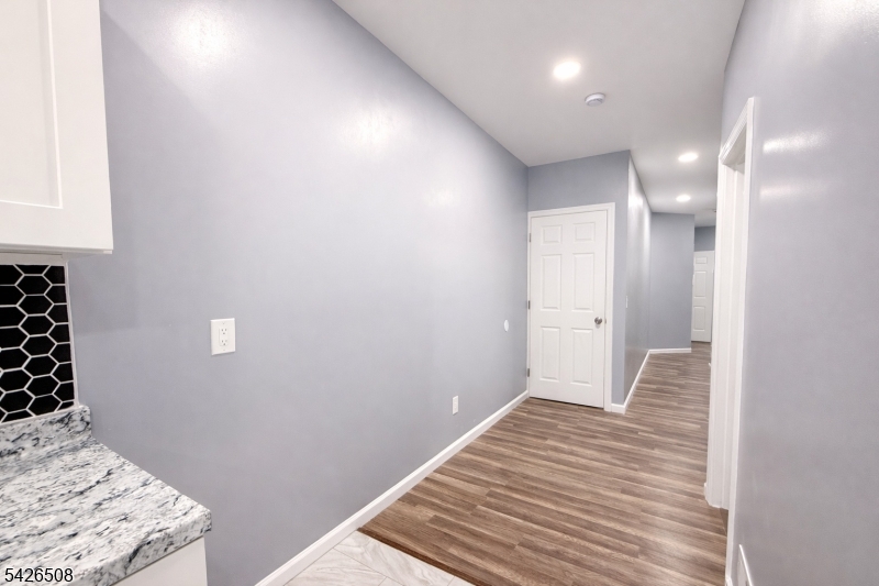 411 South 16th Street, Unit 1 Newark, NJ 07103 - Photo 6 of 39 a view of a bedroom with wooden floor