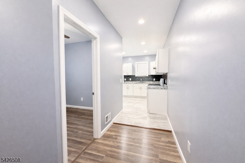 411 South 16th Street, Unit 1 Newark, NJ 07103 - Photo 8 of 39 a view of a kitchen from the hallway