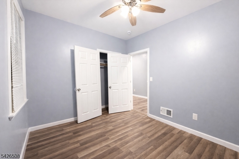411 South 16th Street, Unit 1 Newark, NJ 07103 - Photo 10 of 39 an empty room with wooden floor and windows