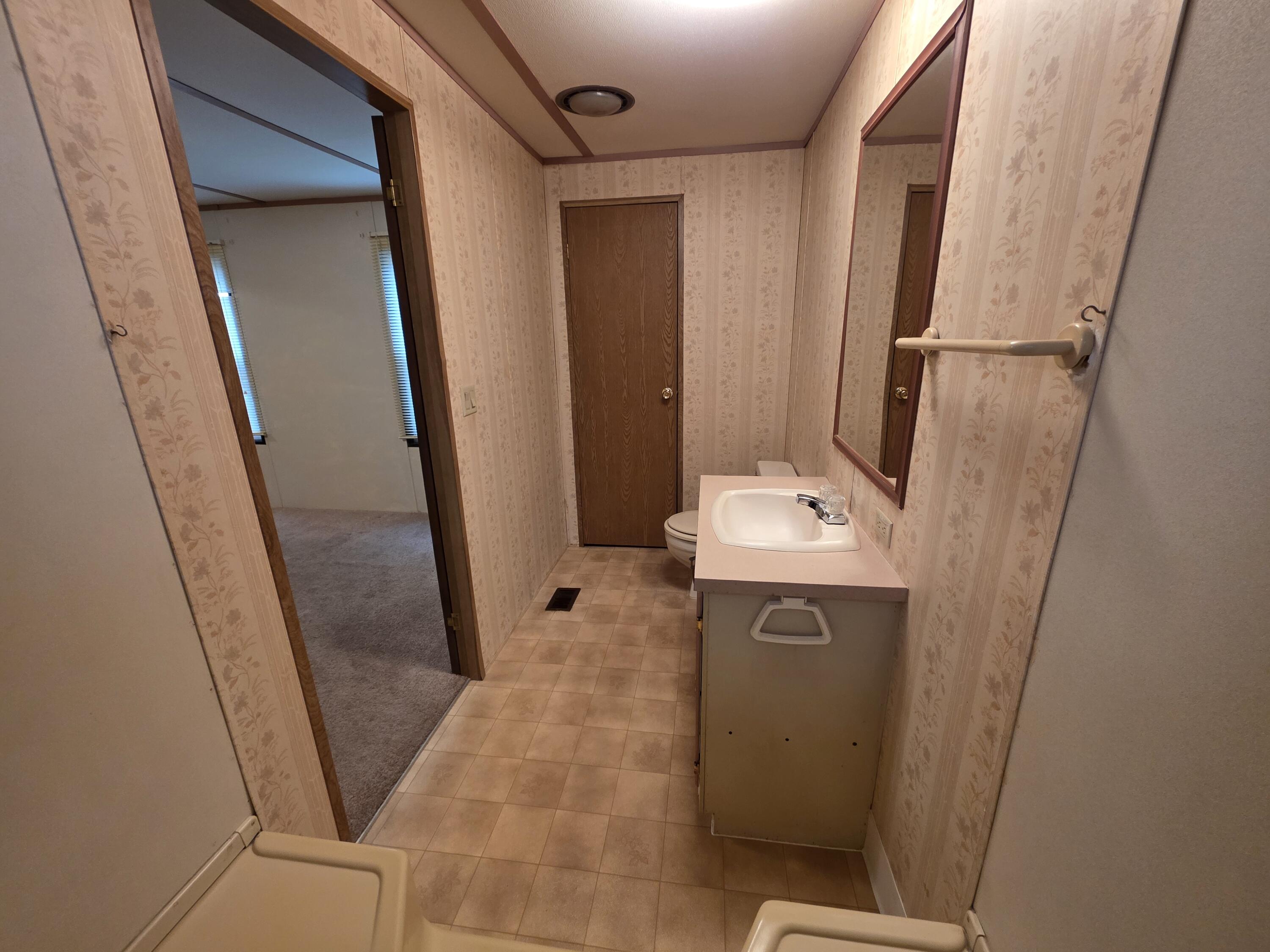 301 Freeman Road, Unit 30 Central Point, OR 97502 - Photo 8 of 26 a bathroom with a sink a mirror and a shower