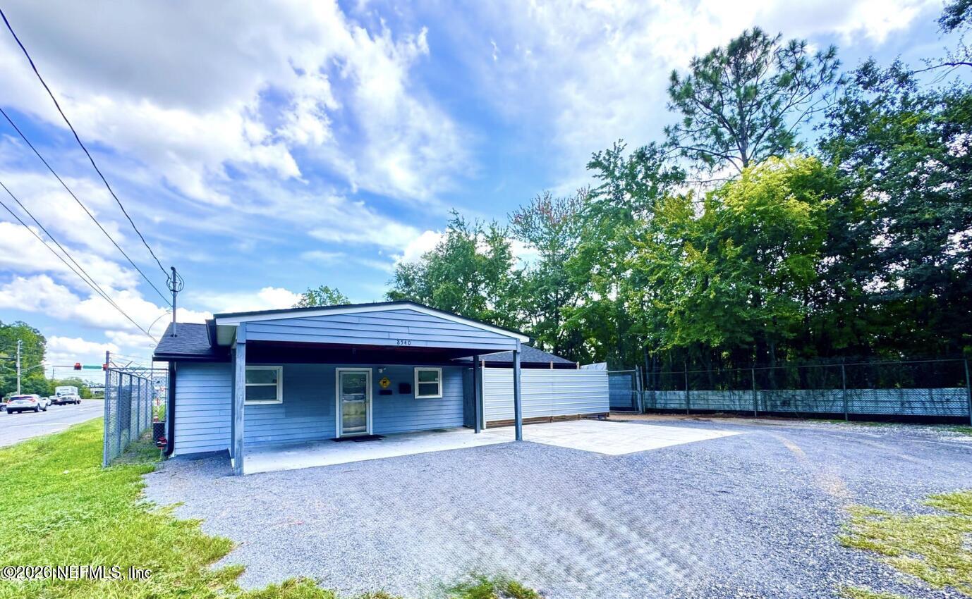 8540 West Beaver Street Jacksonville, FL 32220 - Photo 1 of 18 a front view of a house with garden