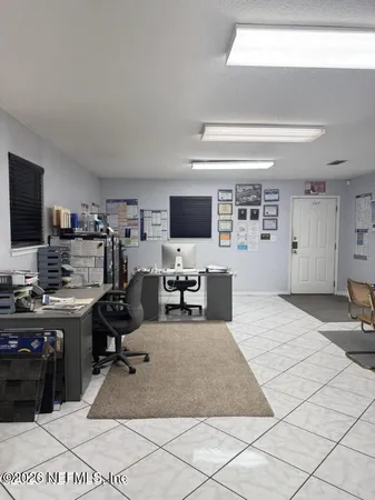 a view of a workspace with furniture and a flat screen tv