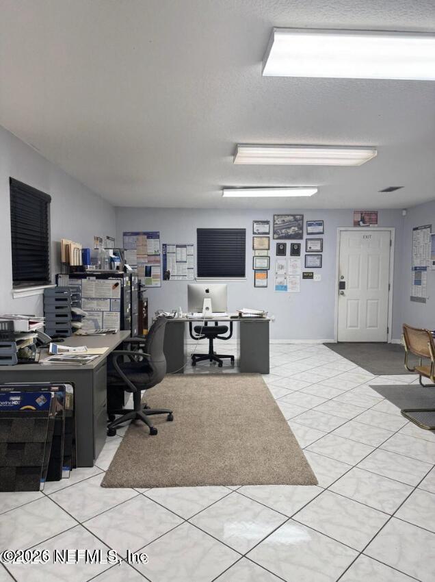 8540 West Beaver Street Jacksonville, FL 32220 - Photo 11 of 18 a view of a workspace with furniture and a flat screen tv