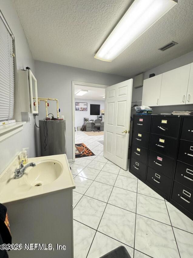 8540 West Beaver Street Jacksonville, FL 32220 - Photo 17 of 18 a spacious bathroom with a sink vanity and mirror