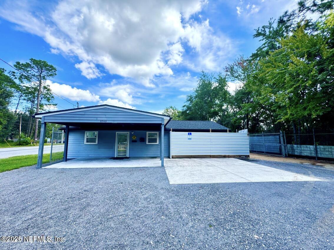 8540 West Beaver Street Jacksonville, FL 32220 - Photo 2 of 18 a front view of a house with garden