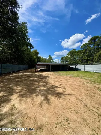a view of swimming pool with seating area and green space