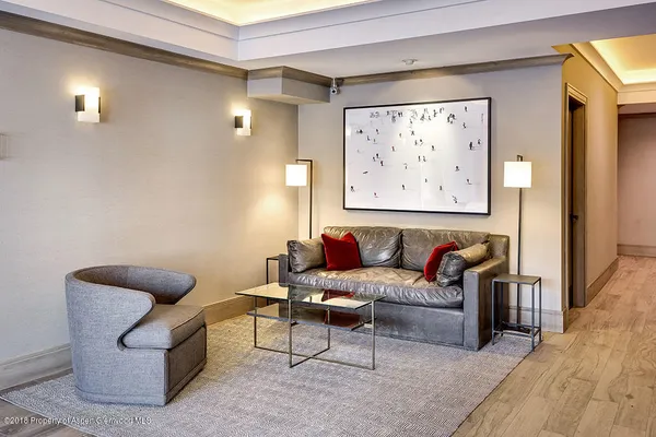 a living room with furniture and a painting