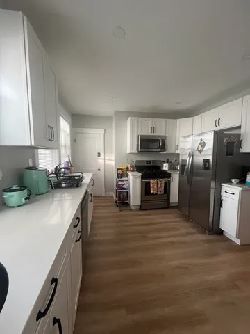 a kitchen with stainless steel appliances a refrigerator sink and microwave