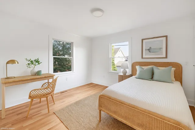 a bedroom with a large bed and a window