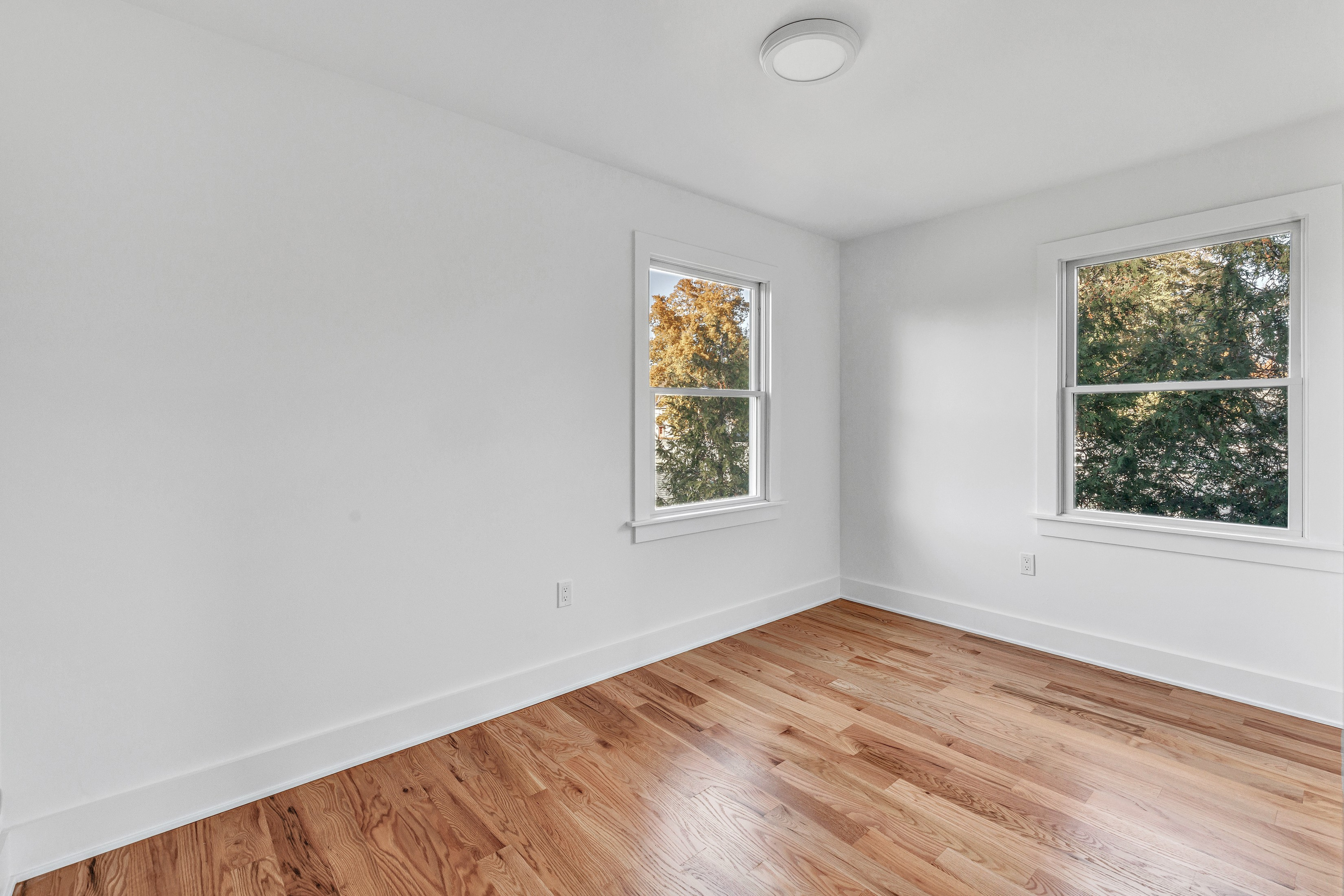 212 Milford Point Road Milford, CT 06460 - Photo 22 of 38 an empty room with wooden floor and windows