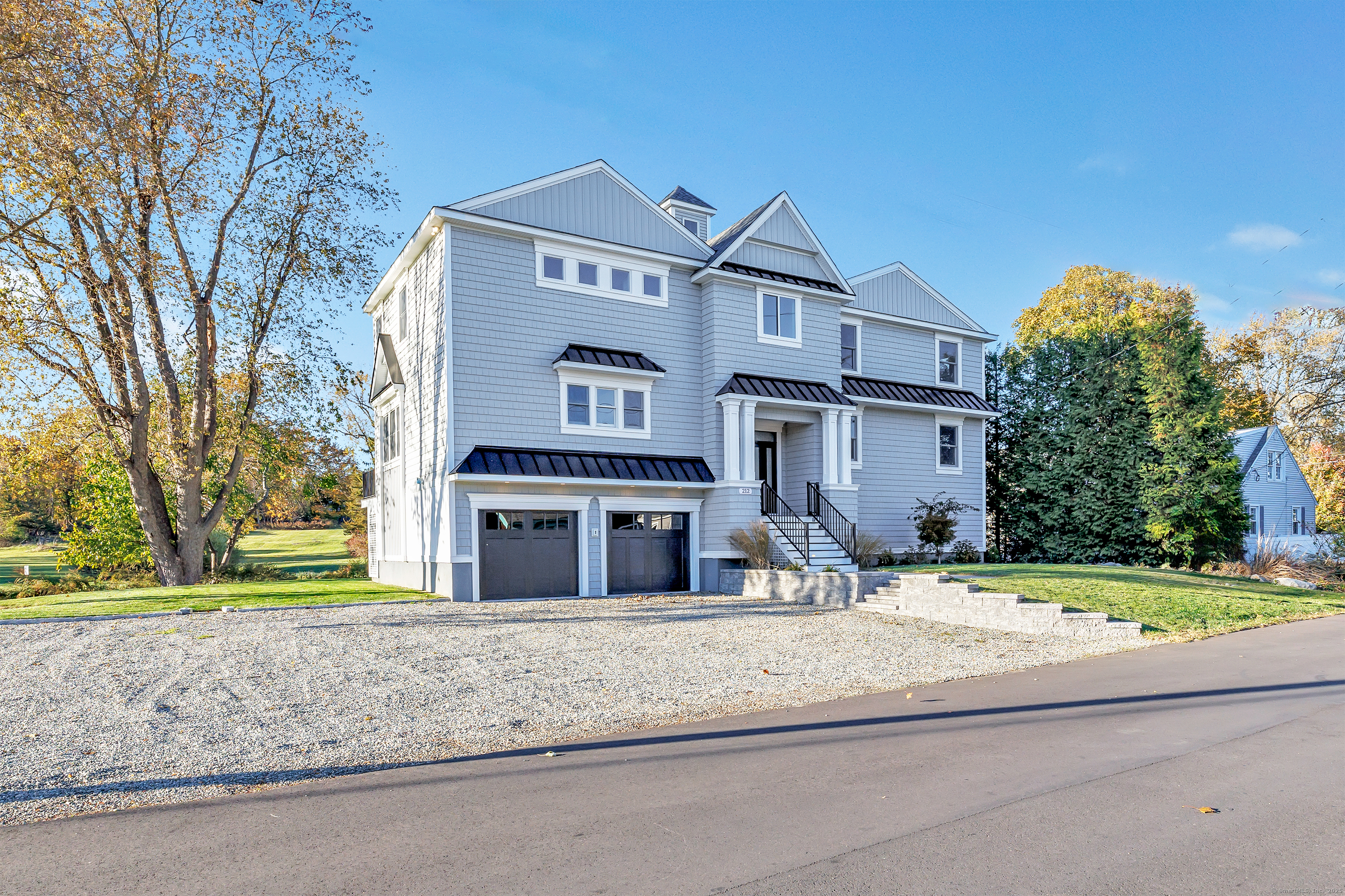 212 Milford Point Road Milford, CT 06460 - Photo 29 of 38 front view of a house with a yard